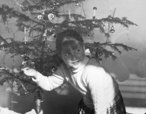 istock Little Girl under Christmas Tree in 1954. 1354858869