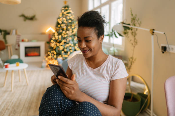 istock Using a smartphone at home on the Christmas morning 1354858928