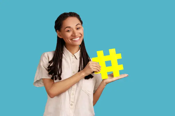 Photo of Woman showing yellow hashtag, internet community, famous blog content, promotion.