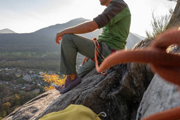 istock Male mountain climber takes a break to enjoy the view 1354859111