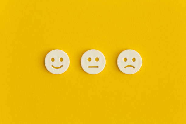 istock Emoticon smile on a yellow background. Customer feedback. 1354859317