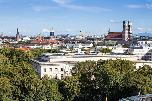 Munich from above: A view from Königsplatz square over the Central Institute for Art History to the cathedral Frauenkirche (Church of Our Lady). The alps on the horizon.