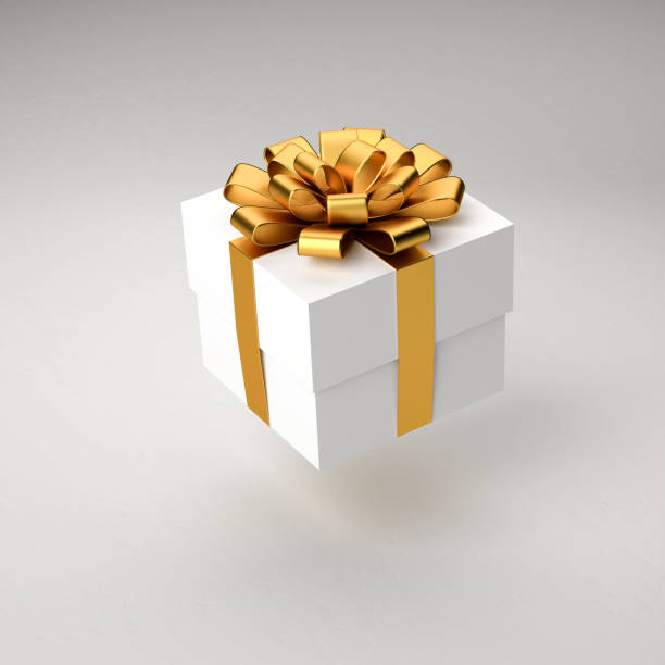istock A white gift box with golden ribbon and bow hovering over a white background. 1354861948