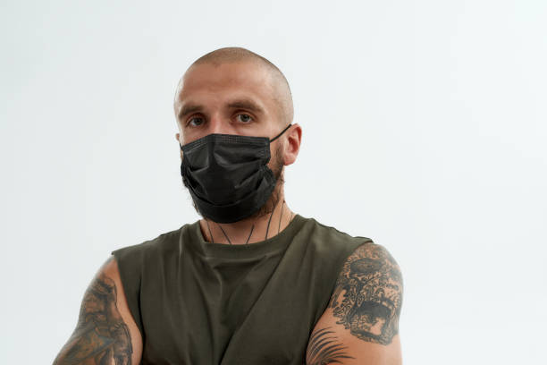 istock Caucasian man in medical mask looking at camera 1354861975