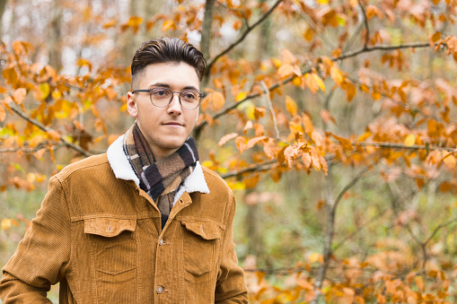 19 year old man out walking in Autumn woodland.