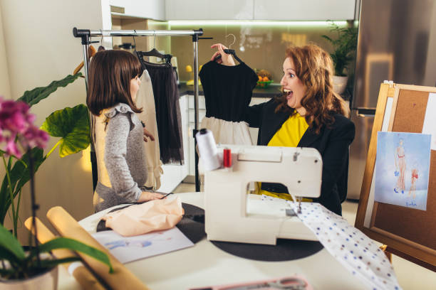istock Young woman sewing with her daughter. 1354863824