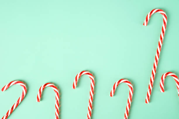 istock red candy cane group on pastel green background 1354864088