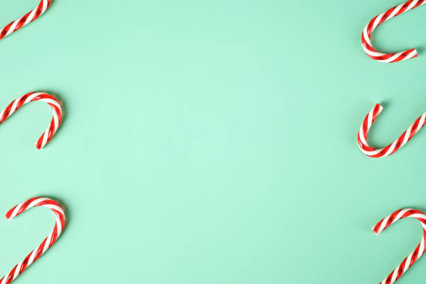 istock red candy cane group on pastel green background 1354864134