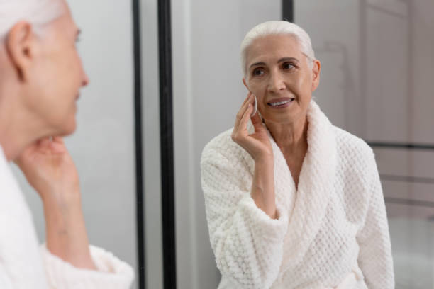 istock Beautiful old lady wipes her face with sponge 1354865900
