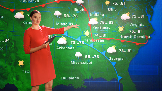 Live Weather News Studio with Professional Female On-Camera Meteorologist Standing Beside Screen and Making Gestures to Point at Weather Synoptic Map Chart for United States of America