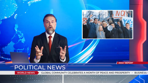 istock Live News Studio with Male Anchor Reporting on the Protesters March, Human Rights, Climate Change and any other Imporant Issues. Presenter, Anchor Talking. Mock-up Television Channel Newsroom Set 1354866047