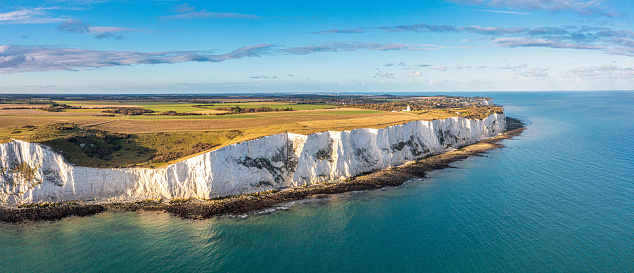 Drone view of the Beachy Head lighthouse with tall, white and chalky cliff, South Downs, Sussex, England, United Kingdom, Europe