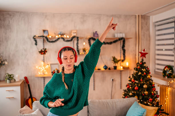 istock Woman singing and dancing at home at Christmas 1354867699