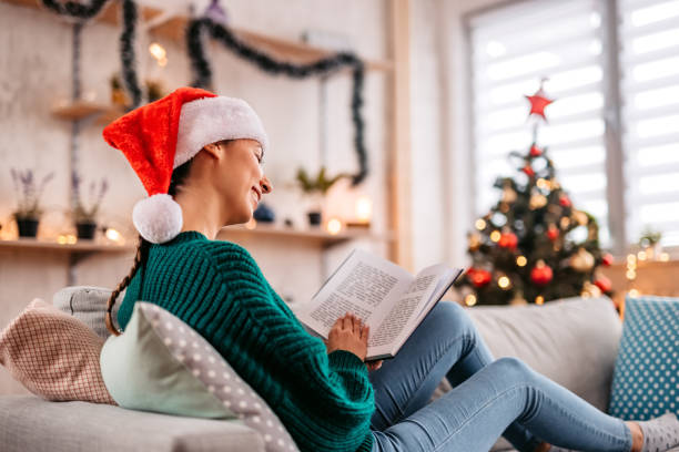 Woman reading book at Christmas