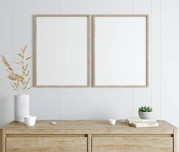 istock Mockup poster frame in modern interior with white wall and wooden console, home interior with plant, 3d rendering 1354869523