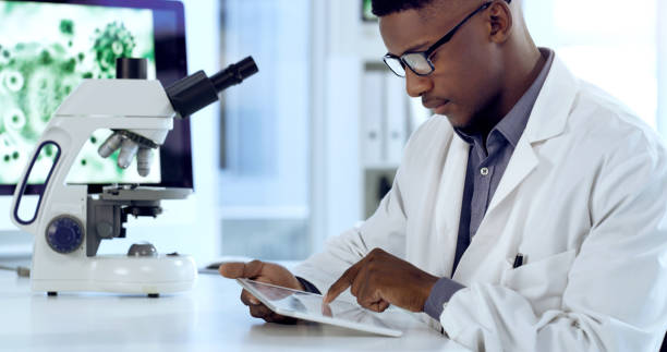 istock Shot of a young male scientist using a digital tablet in an office at work 1354871128
