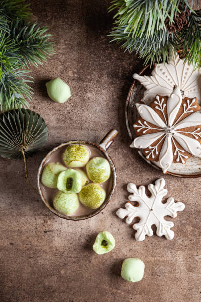 istock Cocoa with marshmallow in a ceramic cups and homemade gingerbread snowflakes. 1354871379