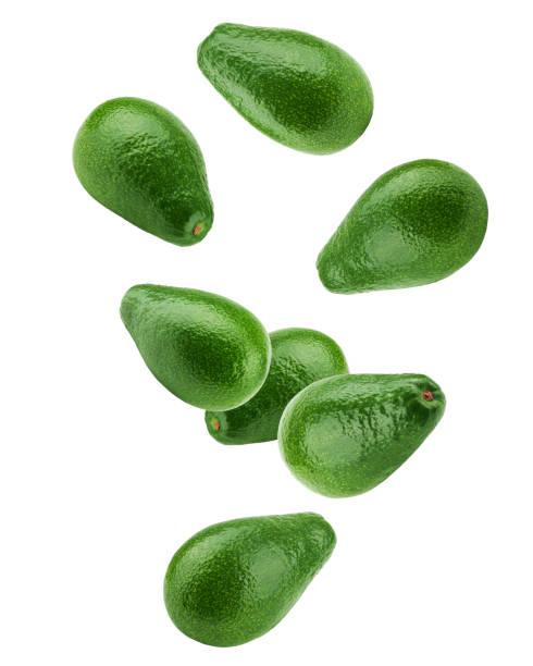 avocado che cade isolato su sfondo bianco, profondità di campo completa, percorso di ritaglio - half full apple green fruit foto e immagini stock