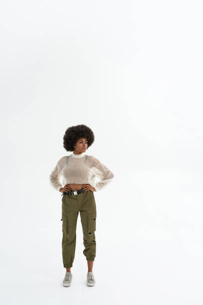 istock Young focused black woman with hands on hips 1354873802