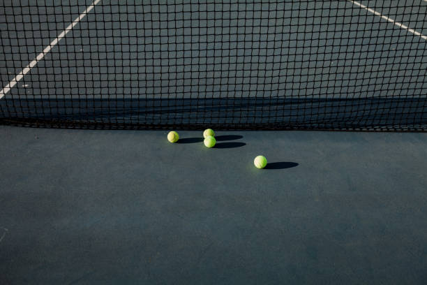 istock tennis balls on court 1354874140