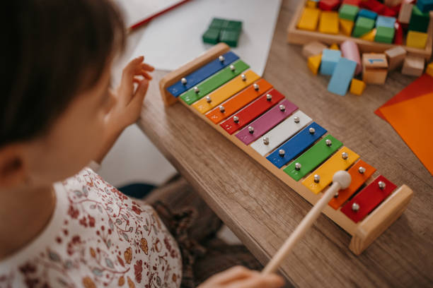 Little girl playing xylophone