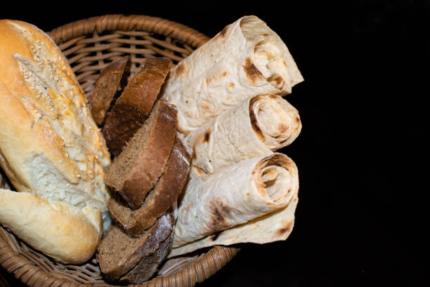 istock Bread in a bowl. Black and white bread. Lavash and loaves 1354877487
