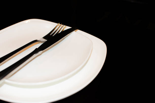 istock Plates with knife and fork. Empty food plate. Fork and knife in a plate 1354877567