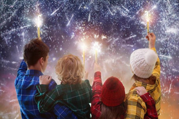 Happy new year. Family watching fireworks. stock photo