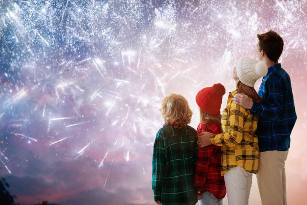 istock Happy new year. Family watching fireworks. 1354878424