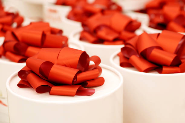 istock White round boxes with red ribbons for gifts 1354879645