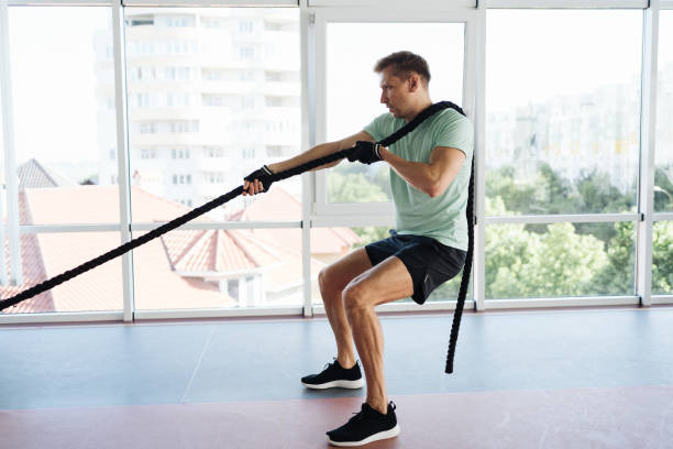 istock Young athlete man is training with rope in a space with a lot of light 1354880012