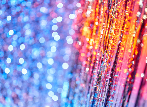 A holiday abstract lighting. Defocused bokeh lights. A shining glittering glowing background
