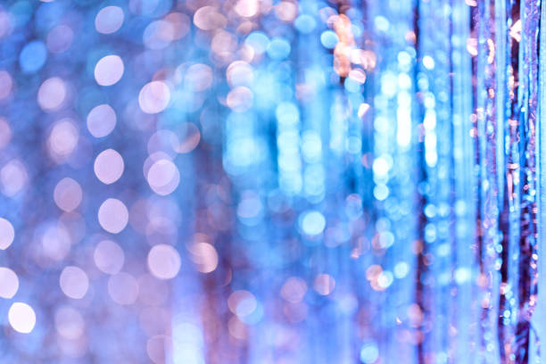 A holiday abstract lighting. Defocused bokeh lights. A shining glittering glowing background