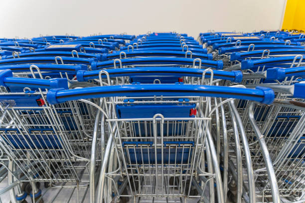 istock trolley parking in a hypermarket, Light blue shopping carts, Many empty shopping carts in a row 1354882740