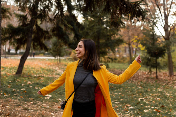 istock Careless girl is enjoying autumn. 1354882887