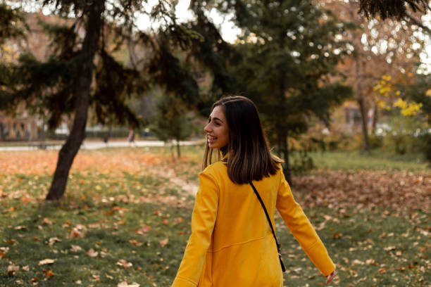 istock Careless girl is enjoying autumn. 1354882889