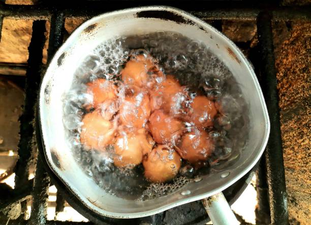 istock Boiling Eggs on stove - food preparation. 1354883108