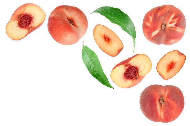 istock Ripe chinese flat peach fruit and half with leaf isolated on white background. Top view. Flat lay 1354884442