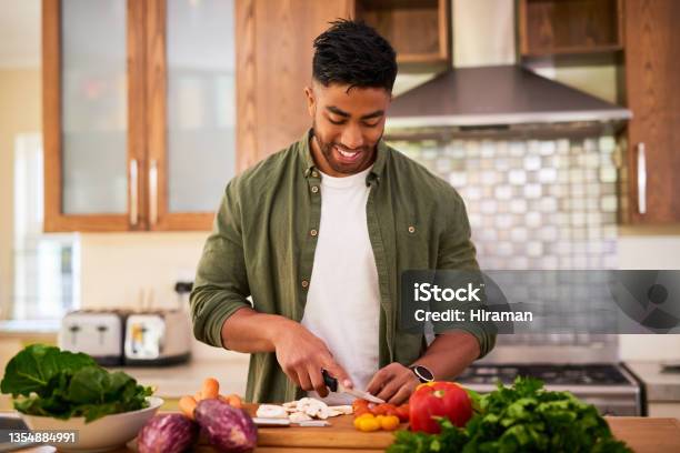Shot Of A Young Man Preparing Vegetables To Cook A Meal Stock Photo - Download Image Now