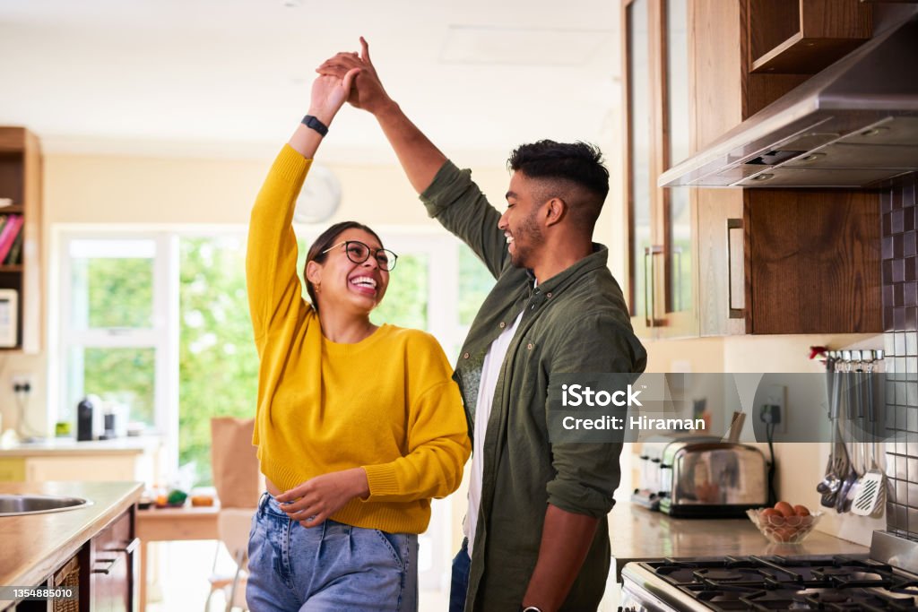 Shot of a young couple dancing together in their kitchen I could dance with you forever Couple - Relationship Stock Photo