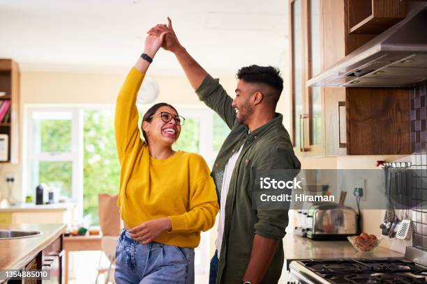 Shot Of A Young Couple Dancing Together In Their Kitchen Stock Photo - Download Image Now