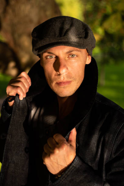 istock Adult handsome man in a coat and cap. 1354887741