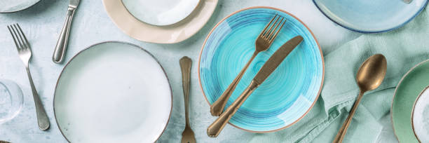 istock Tableware and cutlery panorama, shot from the top, with a vibrant blue plate 1354888260