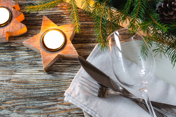 istock Christmas table setting with candles and fir branches 1354888399