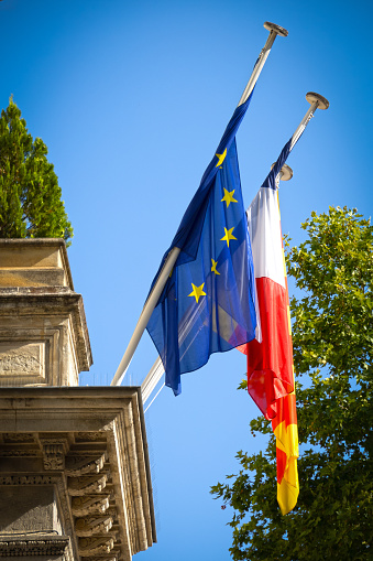 flags on the facade of a town hall
