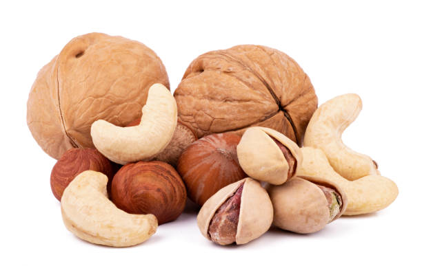 istock Mix of nuts close up isolated on white background 1354889134