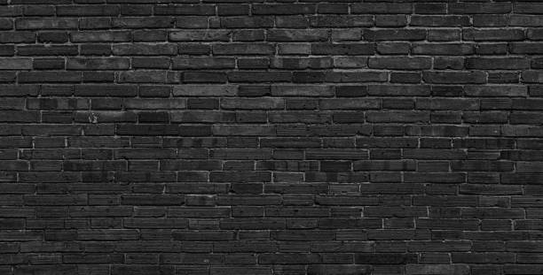 istock Texture of old black brick wall large background. 1354889167