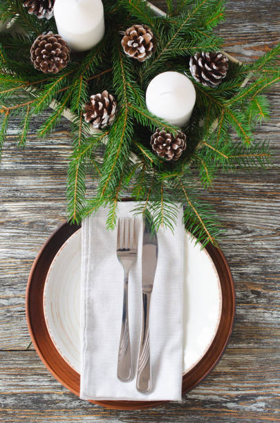istock Christmas table setting with candles and fir branches 1354889694