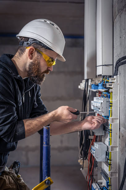 istock A male electrician works in a switchboard with an electrical connecting cable. 1354891289