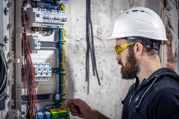 istock A male electrician works in a switchboard with an electrical connecting cable. 1354891296